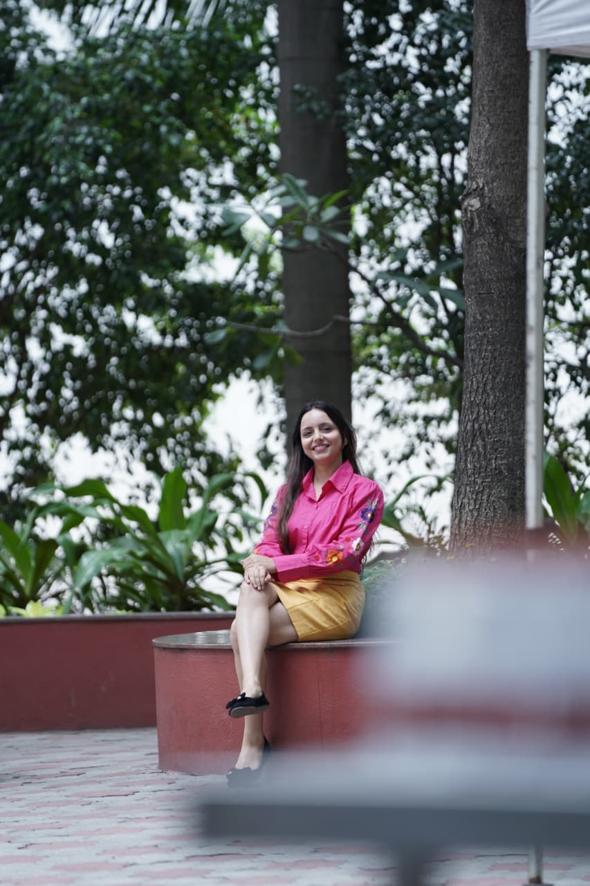 Komal Kumari smiling, seated outdoors